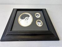 Frontal view of framed sketches showing overall piece