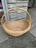Full view of oval wicker basket showing weave and handle