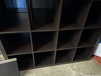 Front view showing cubby layout and dark finish