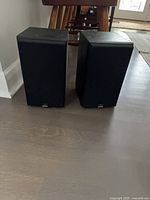 Front view of both Celestion bookshelf speakers showing grilles and logos