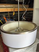 Pendant light resting on surface showing shade exterior and inside socket