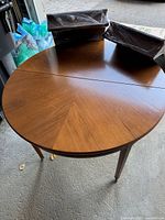 round wooden dining table without leaves attached