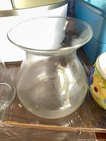 Front view of clear bulbous glass vase