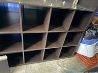 Front view of IKEA black cube bookcase showing 12 cubbies