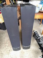 Front view of both black Paradigm tower speakers standing side by side