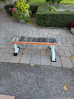 Overall view of flat weight bench on patio