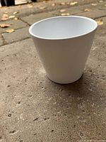 Angled view of white plastic pot showing exterior