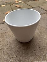 Outside view of white ceramic tapered pot