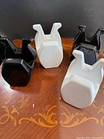 Front view of four porcelain book holders, two black two white