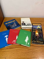 Group shot of six books including The Fairest Fowl, All Too Human, Sacred Journey of the Peaceful Warrior, and three Kate Spade volumes