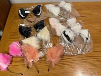 Group shot showing all eight faux-fur cat ear headbands on table