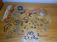 All jewelry items spread on wood surface