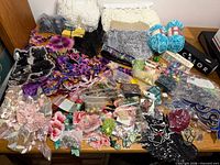 overview of assorted appliqués, trims, beads, yarn and embellishments spread on table