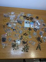 Wide view of entire assortment of charms and findings spread on table