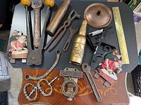 Overall view of assorted tools, hardware, decor on tabletop