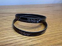 Two slim enamel floral bangles stacked