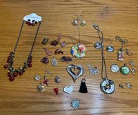 Overall view of all jewelry pieces spread on wooden surface