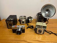 Group shot of four vintage cameras on table