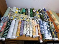 overview of all wallpaper rolls and border samples laid on surface