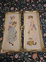 Front view of both needlepoints in frames