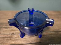 overhead view showing three cigarette rests and round bowl