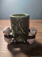 Front view of ceramic planter with three pandas around bamboo cylinder