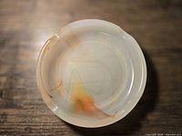 Top view of round onyx ashtray showing veining and rests