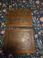 Front view of both carved plaques showing patterns