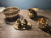 All six brass items together on tabletop