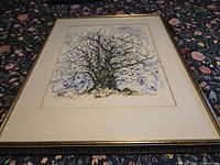 Full view of framed print at angle showing tree image and frame