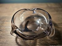 Top view of free-form amethyst glass ashtray showing inner bowl and rim contours