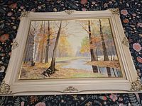 Full view of framed autumn landscape painting