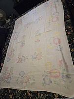 Full view of tablecloth laid flat showing overall size and floral border