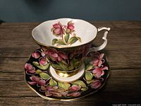 Teacup on saucer, pattern and gold trim visible