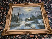 Frontal view of framed winter landscape painting