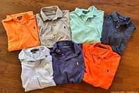 All seven Polo Ralph Lauren shirts laid out showing colors and logos