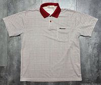 Front view of Aquascutum short sleeve polo shirt, full garment visible