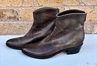 Lateral view of both boots showing leather finish and heel