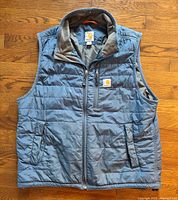 Front view of blue Carhartt quilted vest