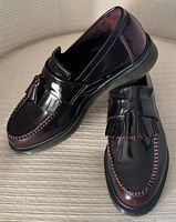 Angled view showing both loafers, tassels, stitching, and outsole