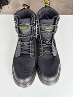 Top view showing pair of boots, laces, tongue branding