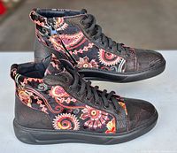 Left and right sneakers side view showing pattern, zippers and soles