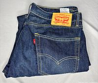 Folded Levi's jeans showing back pocket, red tab, and leather patch