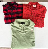 Three folded shirts displayed