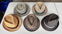 All five hats arranged on table showing styles and colours