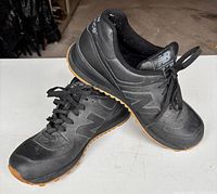 Overall view of both shoes showing uppers and side logos