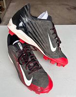 Side view of both cleats showing design, color, condition