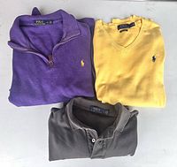All three Polo Ralph Lauren tops folded, showing colors and logos