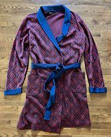Full view of smoking jacket laid flat showing overall design, belt and pockets