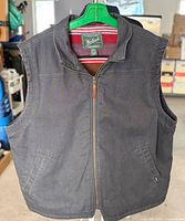 Full front view of Woolrich vest on hanger